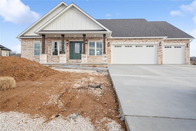 view of front of property featuring concrete driveway, roof with shingles, an attached garage, board and batten siding, and brick siding