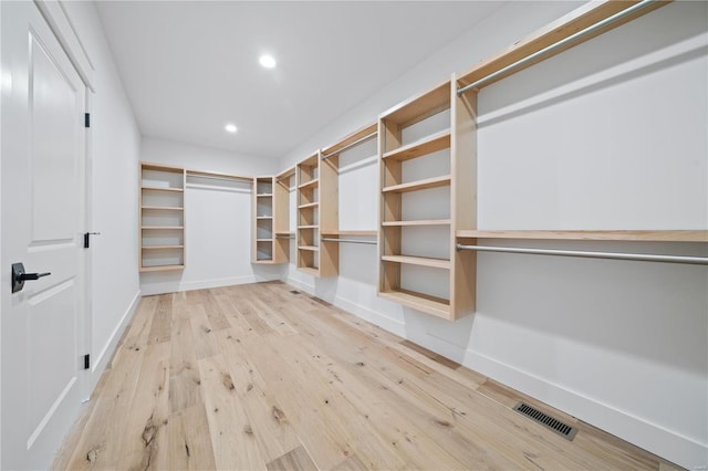 walk in closet featuring light hardwood / wood-style flooring