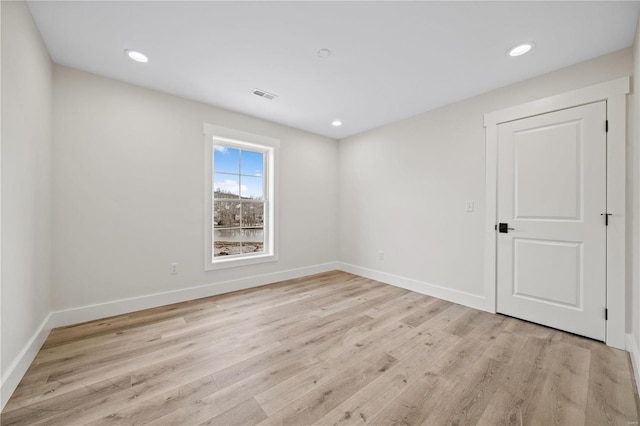 spare room featuring light hardwood / wood-style flooring