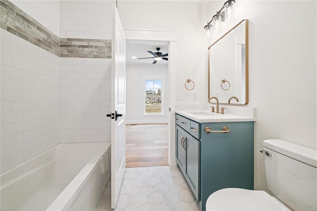 full bathroom with tile patterned flooring, vanity, tiled shower / bath combo, ceiling fan, and toilet