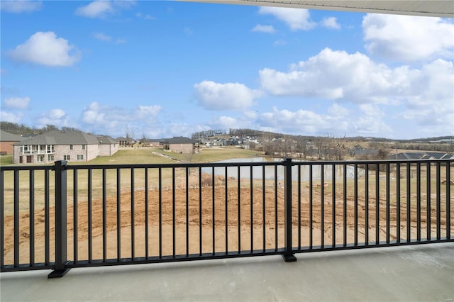 balcony featuring a residential view and a water view