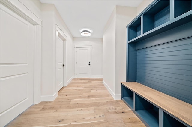 mudroom featuring light wood-style floors and baseboards