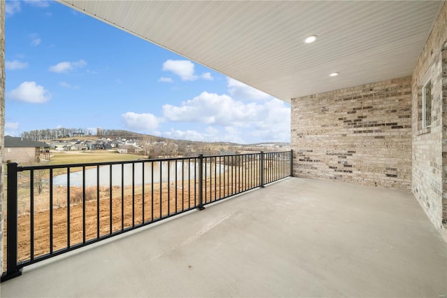 balcony with a water view and a patio area