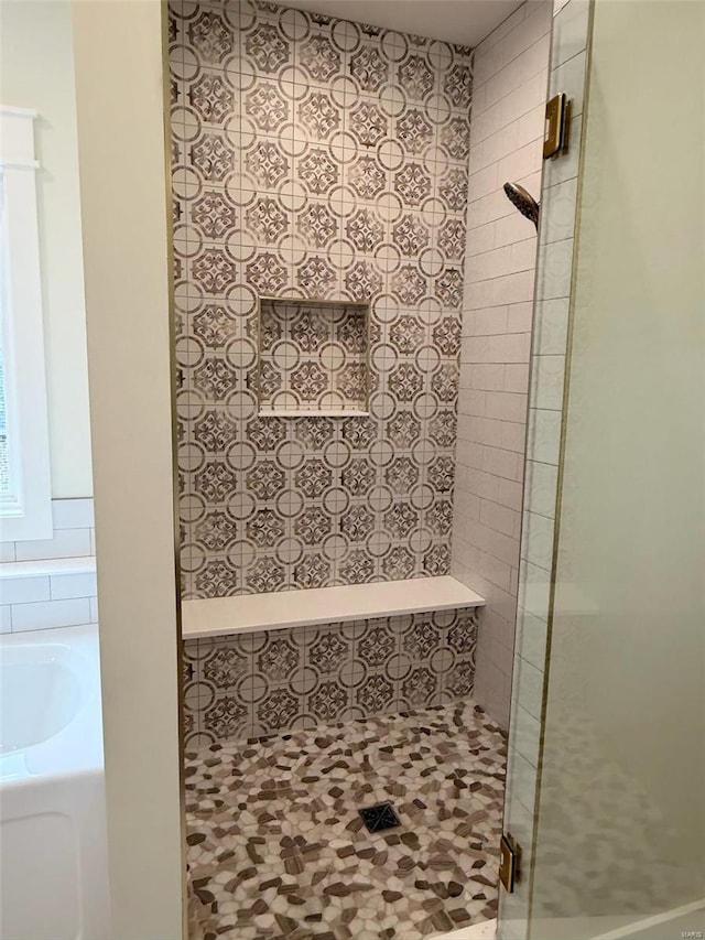 full bath featuring a shower stall and a bath