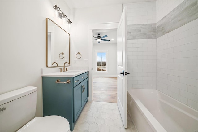 full bath featuring toilet, ceiling fan, tile patterned floors, vanity, and shower / bathing tub combination