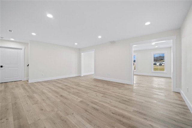 spare room with light wood-type flooring, baseboards, and recessed lighting