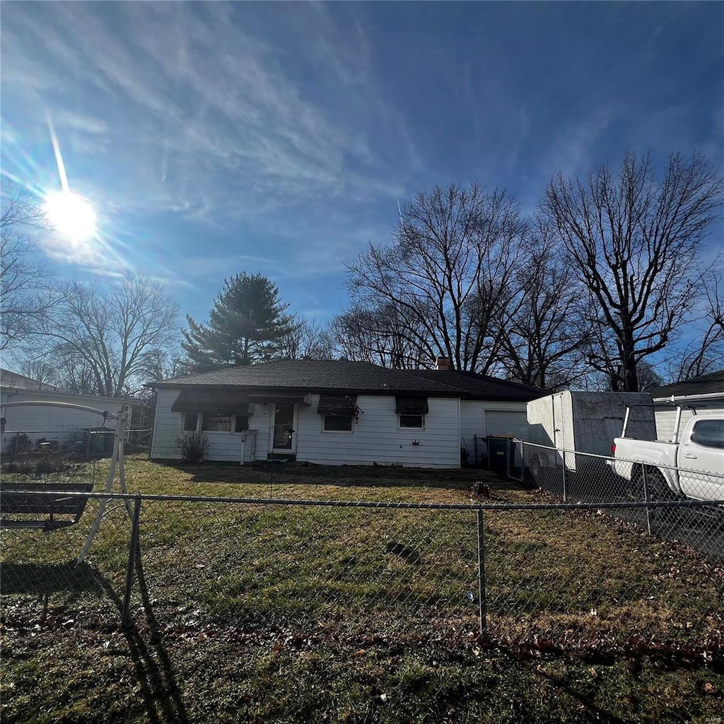 rear view of house with a lawn