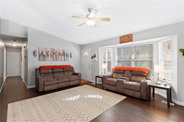 living room featuring lofted ceiling, dark hardwood / wood-style flooring, and ceiling fan