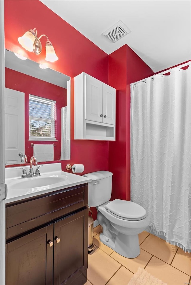 bathroom featuring vanity, tile patterned floors, and toilet