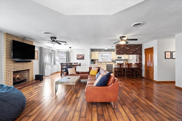 living room featuring dark wood-type flooring, a fireplace, and ceiling fan