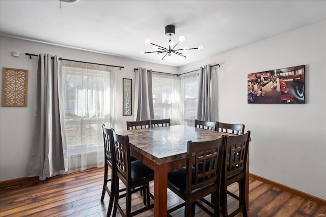 dining space featuring dark hardwood / wood-style flooring and a chandelier