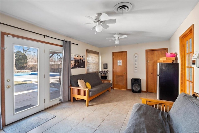 living room with light tile patterned flooring and ceiling fan