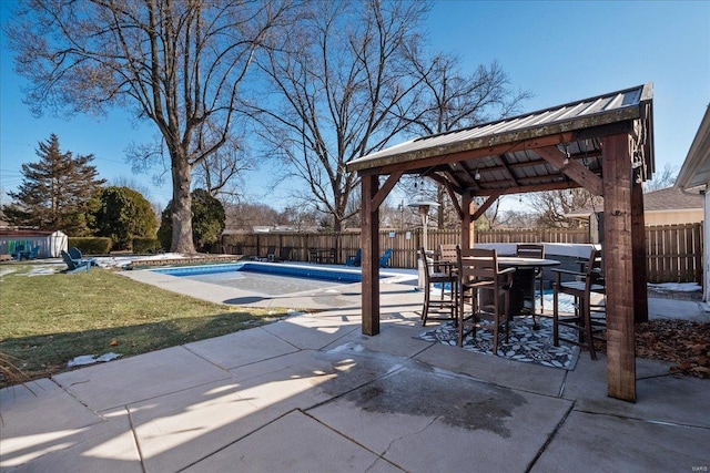 view of patio with a fenced in pool and a gazebo