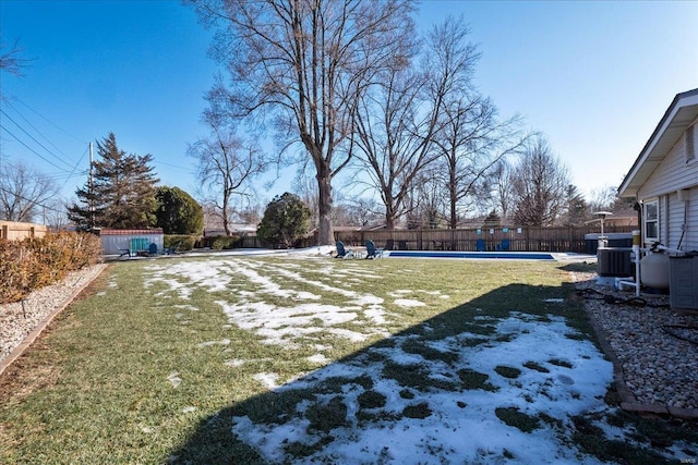 view of yard featuring central AC and a covered pool