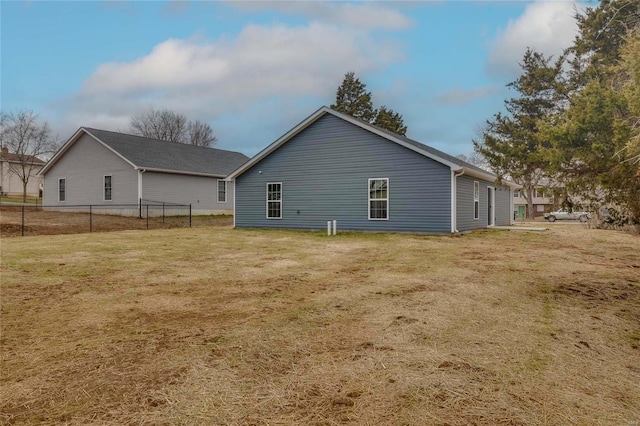 back of property featuring a yard