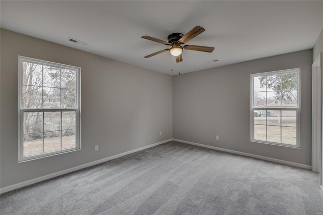 carpeted spare room with ceiling fan