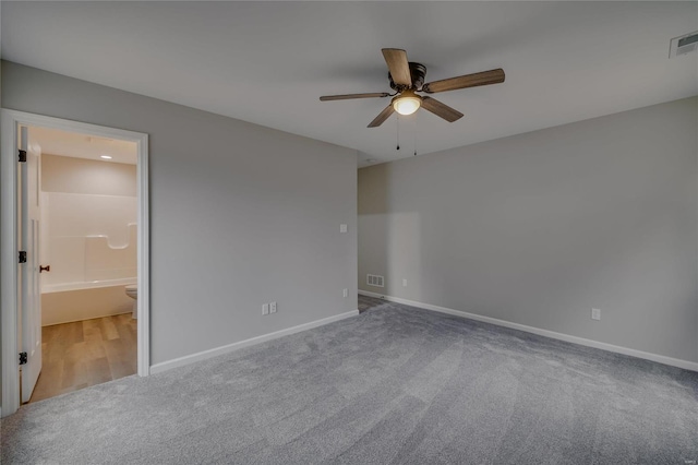 carpeted empty room featuring ceiling fan