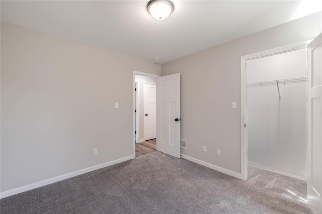 unfurnished bedroom with carpet and a closet