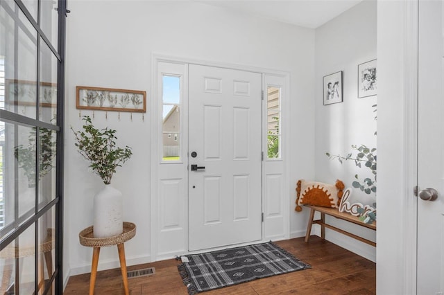 foyer with dark hardwood / wood-style floors