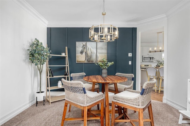 dining room featuring an inviting chandelier, crown molding, and carpet floors