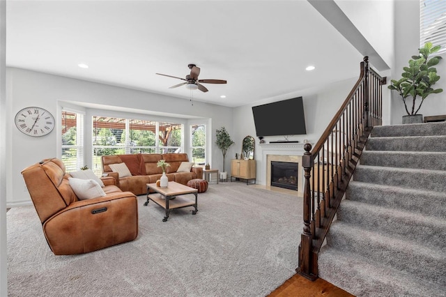 living room with ceiling fan and carpet