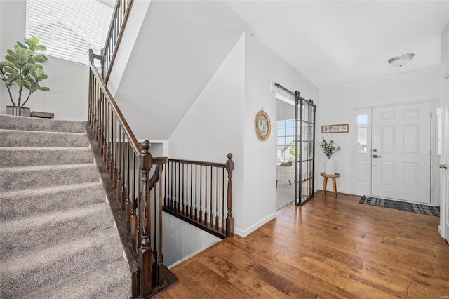 entryway featuring a barn door and hardwood / wood-style floors