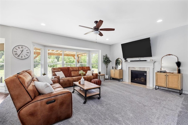 carpeted living room featuring ceiling fan