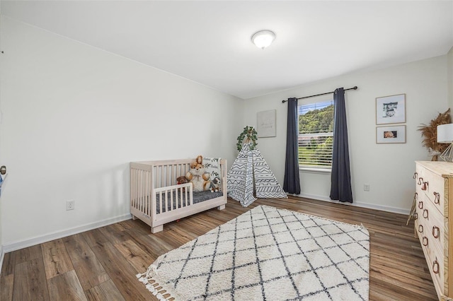 unfurnished bedroom with dark hardwood / wood-style floors