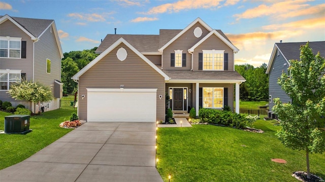 view of front facade with a garage and a lawn