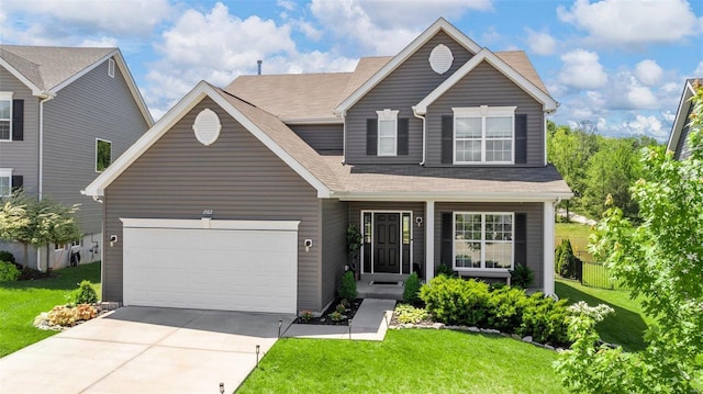 view of front of home with a garage and a front lawn