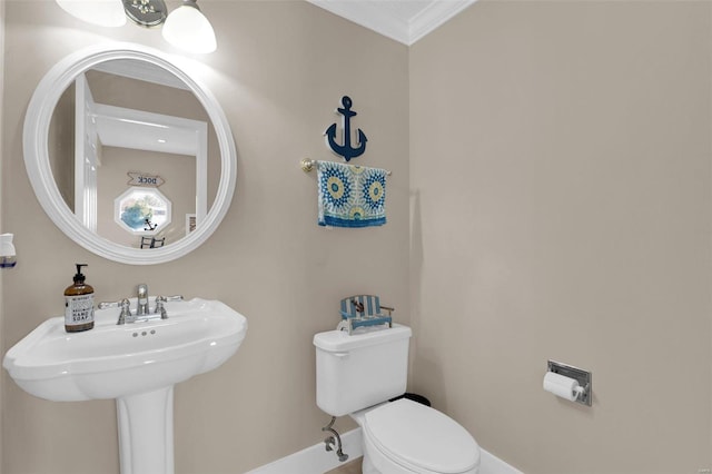 bathroom with baseboards, a sink, and toilet