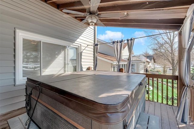 wooden deck with a hot tub