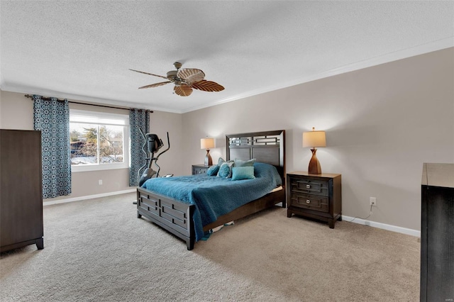 bedroom featuring a textured ceiling, ornamental molding, carpet flooring, and baseboards