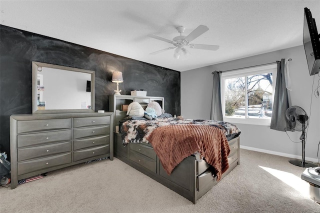 bedroom with light carpet, ceiling fan, baseboards, and a textured ceiling