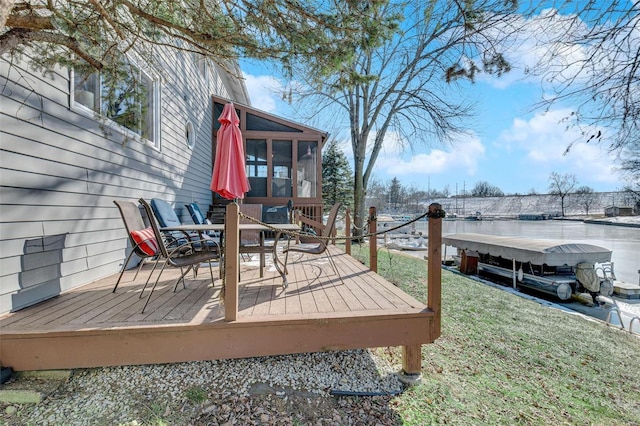 deck with a sunroom and a lawn