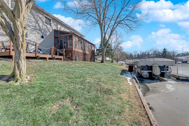 view of yard featuring a wooden deck and a sunroom