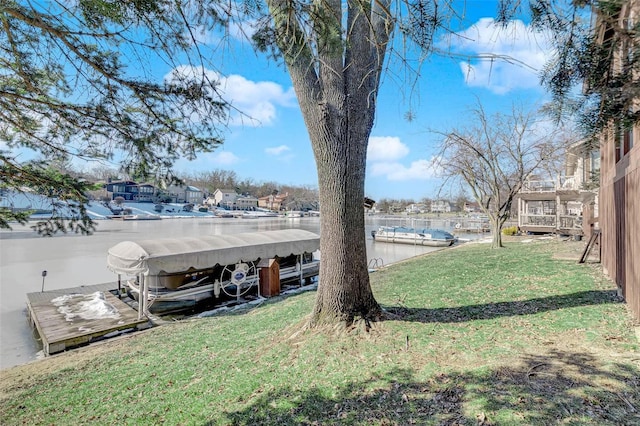 view of yard with a dock and a water view