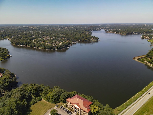 aerial view with a water view and a wooded view