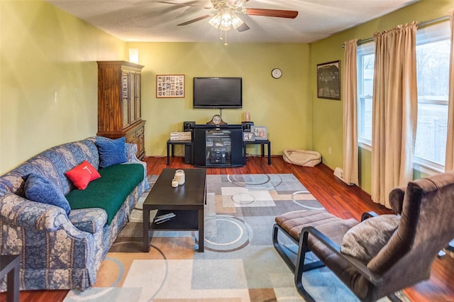 living room with hardwood / wood-style flooring and ceiling fan