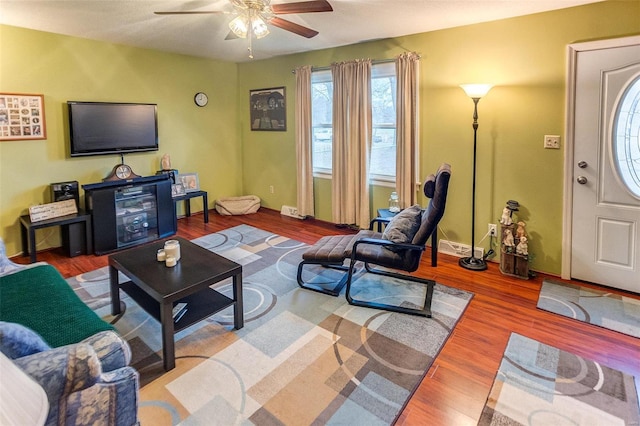 living room with hardwood / wood-style floors and ceiling fan