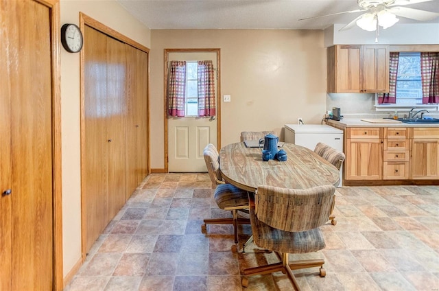 dining space with sink and ceiling fan