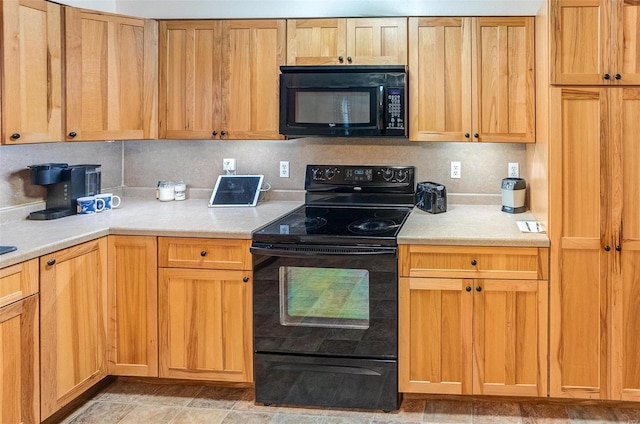 kitchen featuring tasteful backsplash and black appliances