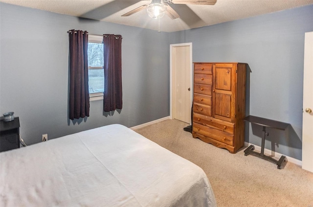 bedroom featuring ceiling fan, carpet floors, and a textured ceiling