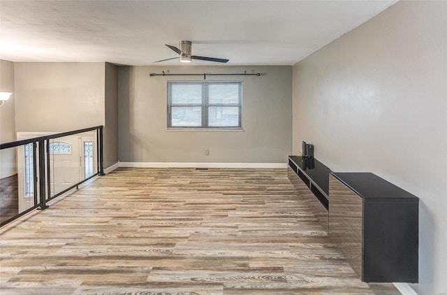 empty room featuring light hardwood / wood-style flooring and ceiling fan