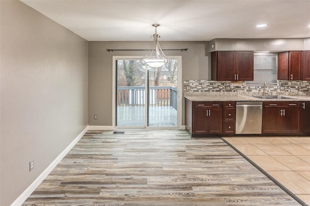 kitchen with tasteful backsplash, dishwasher, sink, and decorative light fixtures