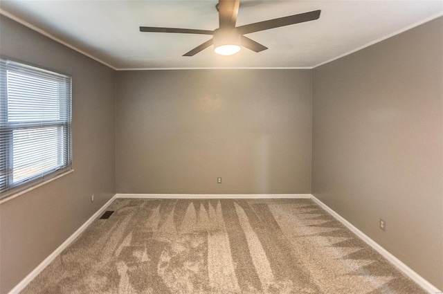 carpeted empty room featuring crown molding and ceiling fan