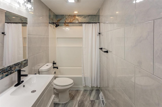 full bathroom with vanity, toilet, shower / tub combo, and tile walls