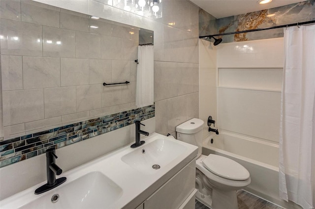 full bathroom featuring sink, tile walls, shower / tub combo with curtain, and toilet