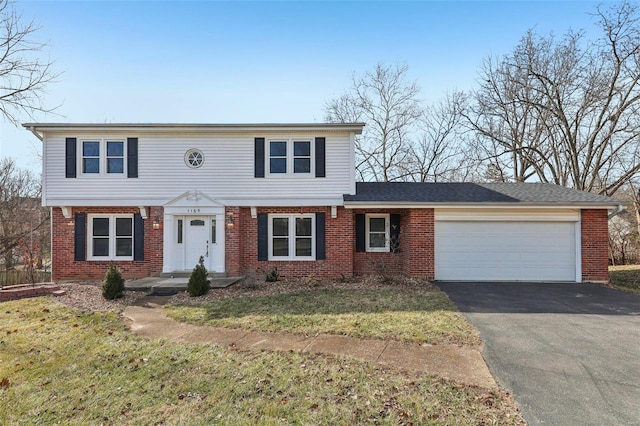 view of front of property featuring a garage and a front lawn