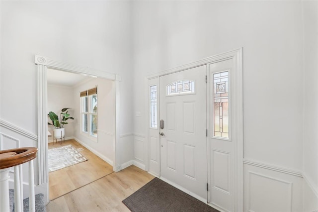 entrance foyer featuring a high ceiling and light wood-type flooring